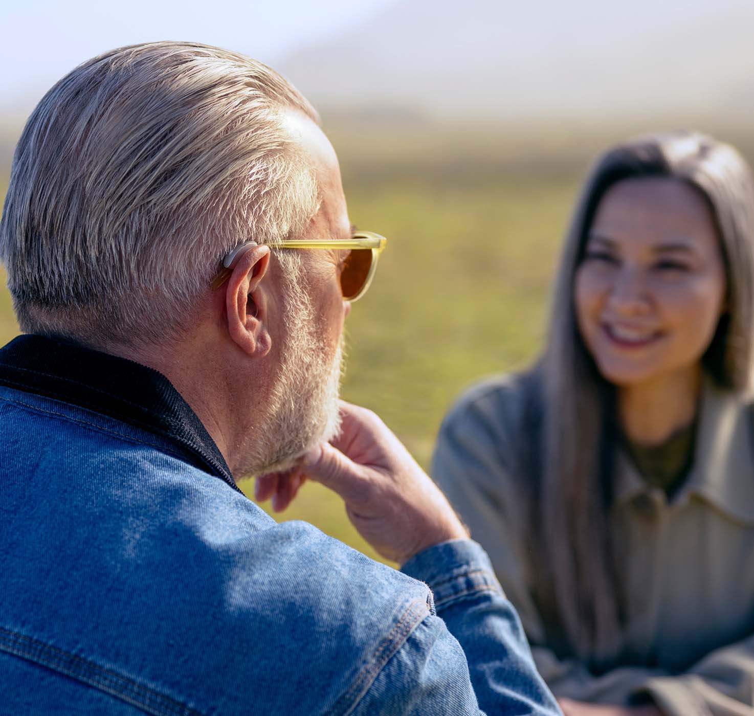 man and woman talking outdoors
